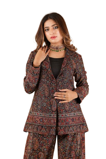 Woman wearing a paisley patterned suit with ornate choker necklace.